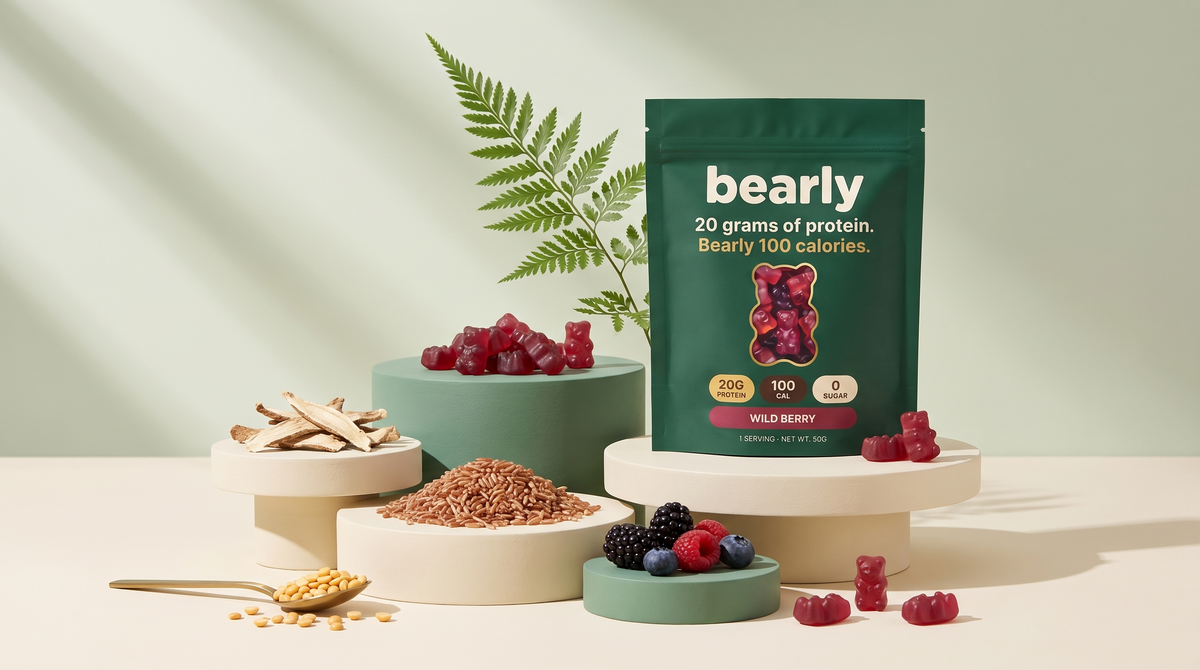 Bearly Wild Berry pouch on cream pedestals surrounded by split peas, rice, chicory root, fresh berries and red gummy bears.